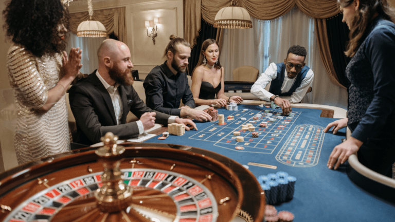 a group of people playing roulette at a casino