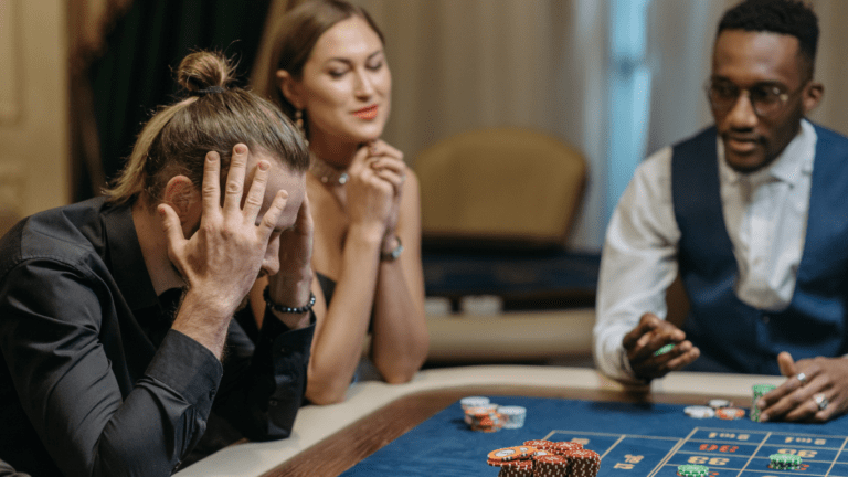 a group of people playing roulette at the casino