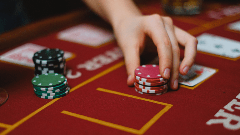 a person playing poker with cards and chips