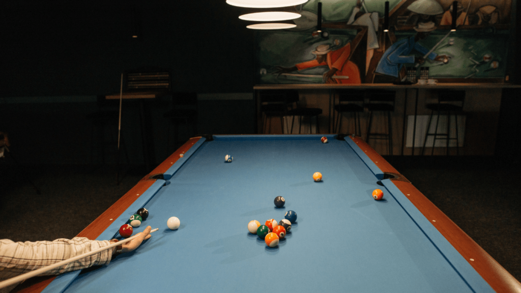 a person playing pool with balls on a table